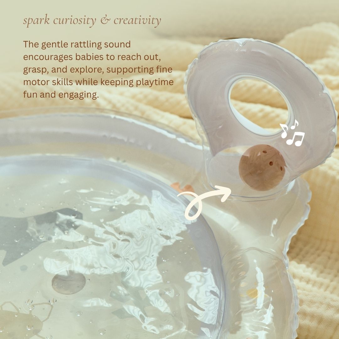 Baby rattle toy with text about encouraging curiosity and creativity